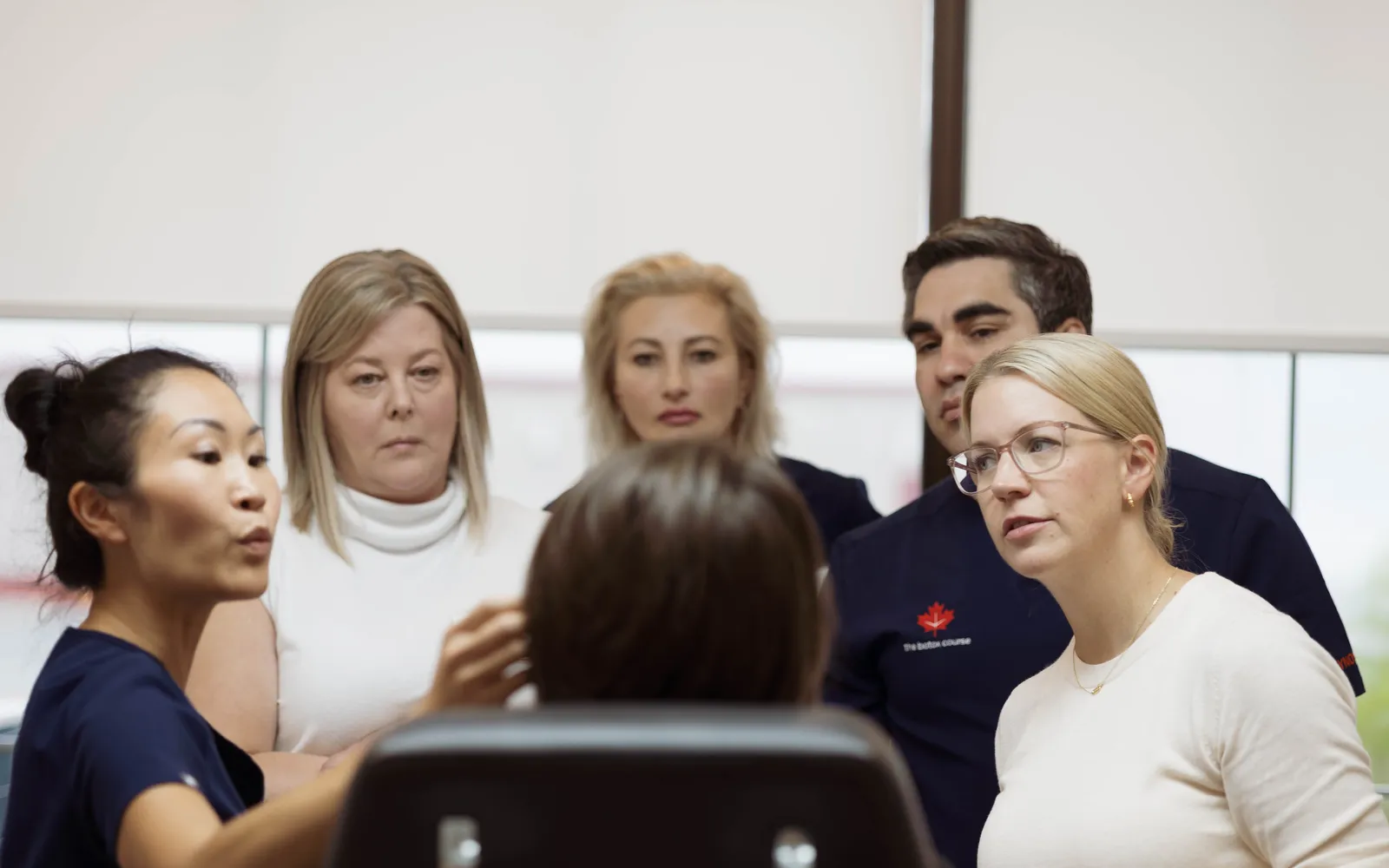 Participantes reunidos en torno a una demostración del claustro durante la formación clínica