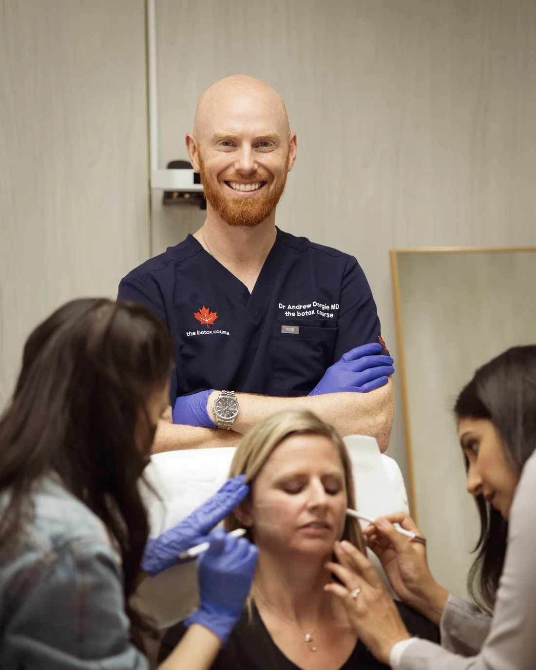 Dr. Andrew Dargie in the training clinic with course participants marking a patient